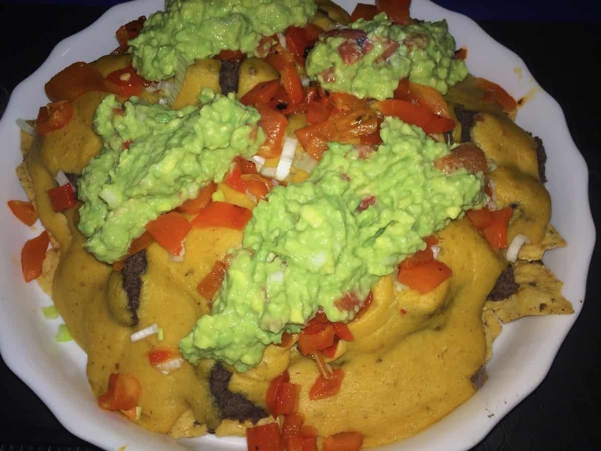 Photo of nachos with vegan potato carrot cheese sauce
