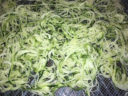 Spiralized zucchini noodles ready to be dehydrated