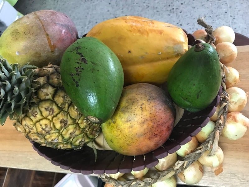 Mango, pineapple, papaya, avocado, and onion from the produce market
