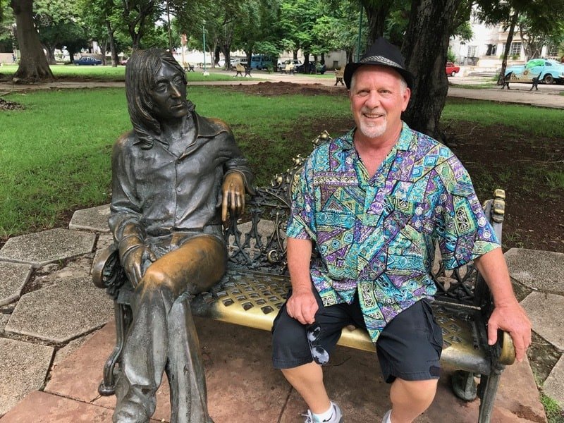 Mark in John Lennon park next to the statue of John Lennon