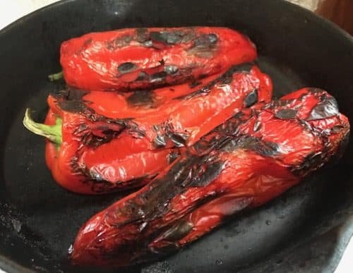 Red peppers roasted in a cast iron pan