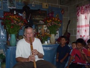 Playing his flute for the kids