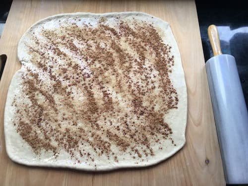 Cinnamon roll dough ready to be rolled up