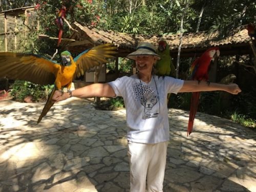 Photo op with birds at Macaw Mountain, Copán