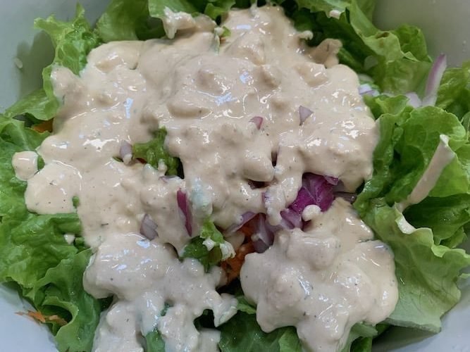 Photo of vegan blue cheese dressing on salad